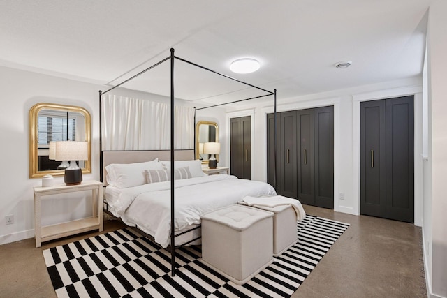 bedroom featuring baseboards and finished concrete floors