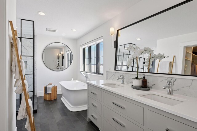 2070 Shoreline Dr, Orono, MN 55391 - bathroom featuring a freestanding bath, double vanity, backsplash, recessed lighting, and a shower
