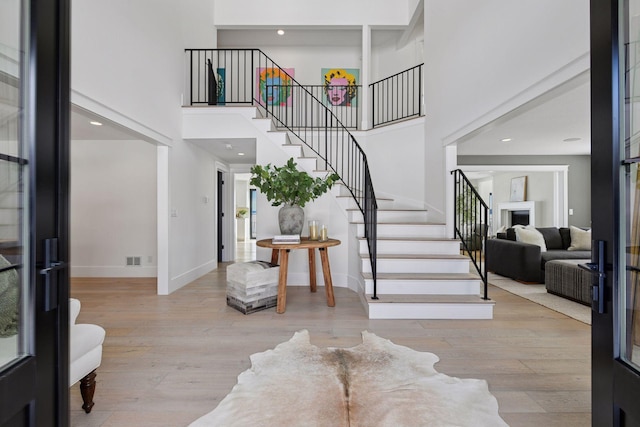 2070 Shoreline Dr, Orono, MN 55391 - entryway with a towering ceiling, stairs, wood finished floors, and recessed lighting
