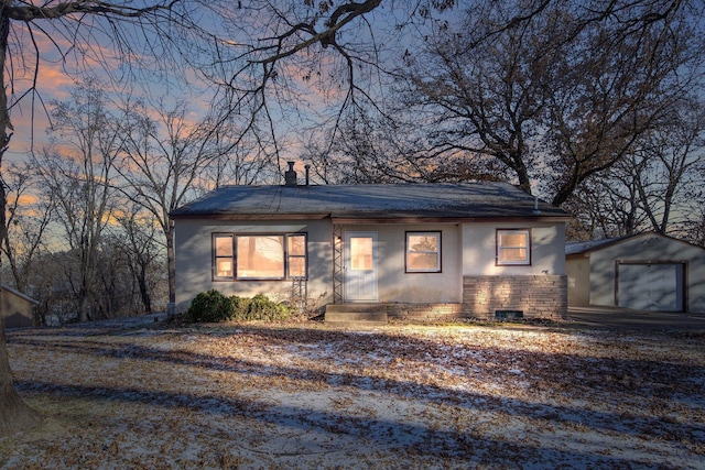 view of front of home featuring a garage and an outdoor structure