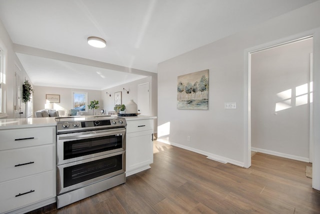 kitchen featuring white cabinets, double oven range, and dark hardwood / wood-style floors