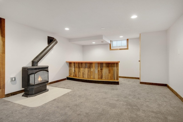 bar with a wood stove and light carpet