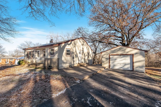 view of front of home with a garage and an outdoor structure