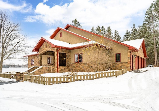 view of front of property with stone siding and stucco siding