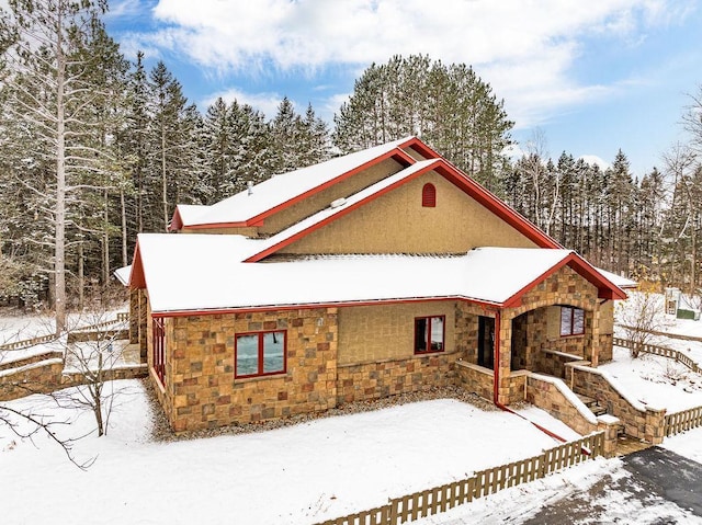 view of front of house with stone siding and stucco siding