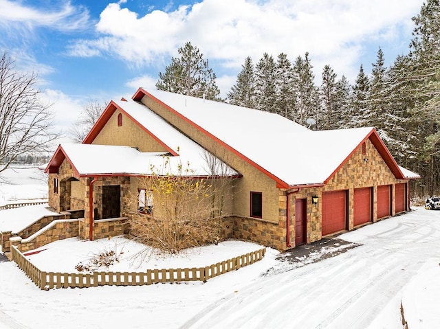 view of front of house with stone siding and stucco siding