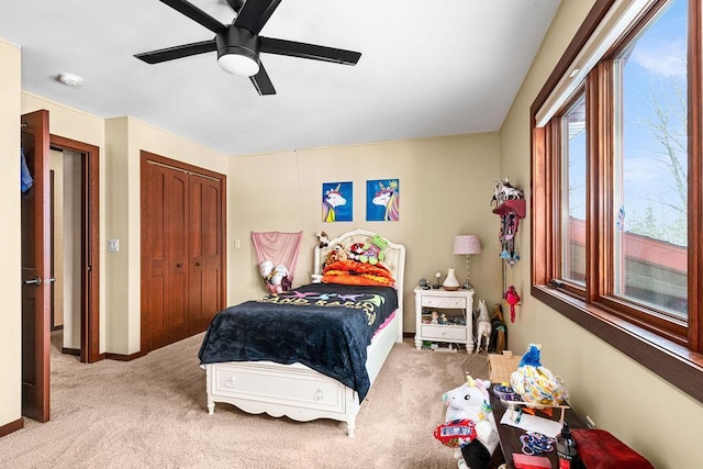 carpeted bedroom with a ceiling fan and a closet