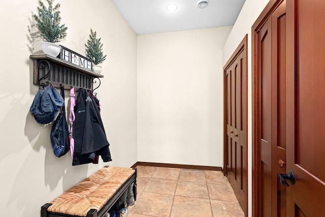 mudroom with baseboards and light tile patterned floors