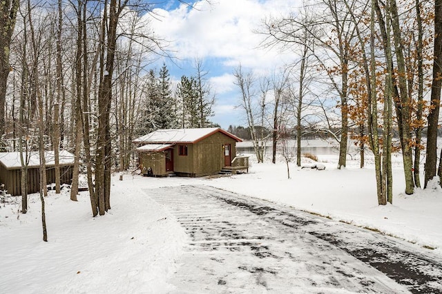 yard covered in snow featuring an outdoor structure