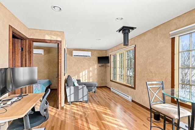 home office with light wood-type flooring, an AC wall unit, baseboards, and baseboard heating