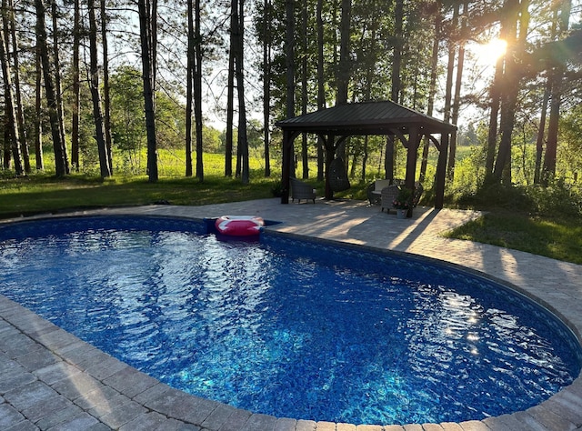 pool with a patio and a gazebo