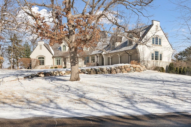 french country home featuring a garage