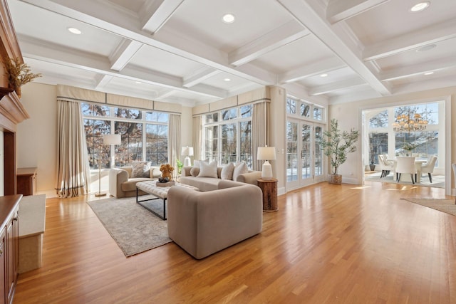 living room with beamed ceiling, coffered ceiling, light hardwood / wood-style floors, and french doors