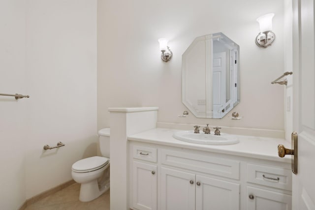 bathroom featuring vanity, tile patterned floors, and toilet