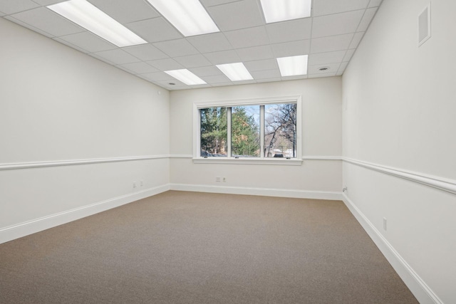 spare room with a drop ceiling and carpet