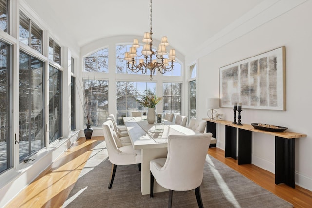 sunroom / solarium with lofted ceiling and a notable chandelier