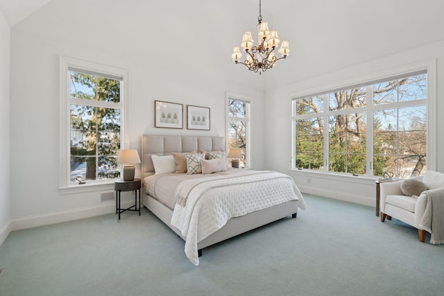 carpeted bedroom featuring lofted ceiling and a notable chandelier