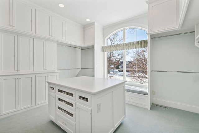 walk in closet featuring light carpet