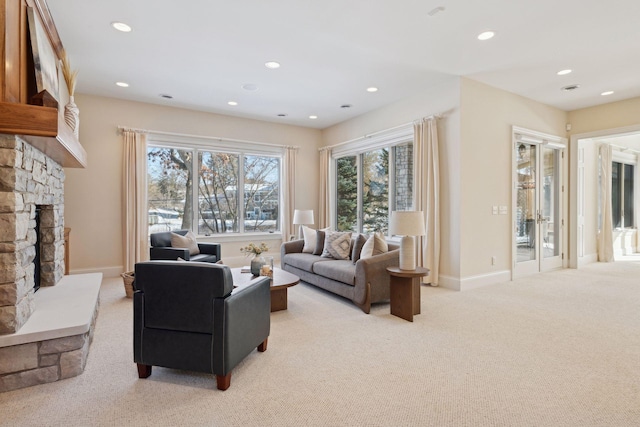 living room featuring a fireplace and light carpet