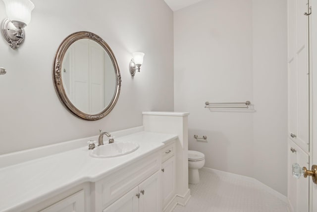 bathroom featuring vanity, tile patterned floors, and toilet