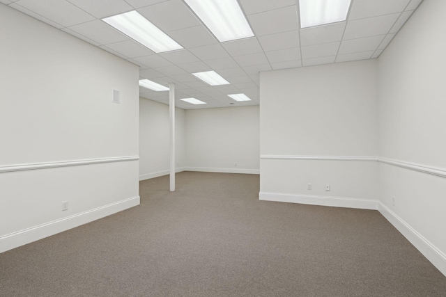 empty room featuring carpet flooring and a drop ceiling