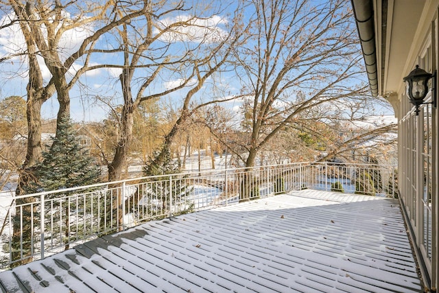 snow covered deck with a water view