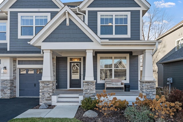 craftsman-style home with a porch and a garage