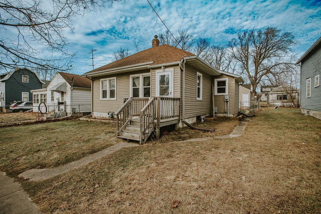 rear view of property featuring a yard