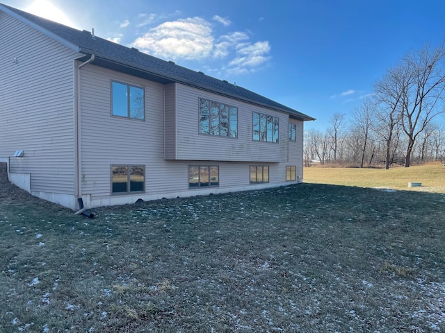 view of property exterior with a lawn