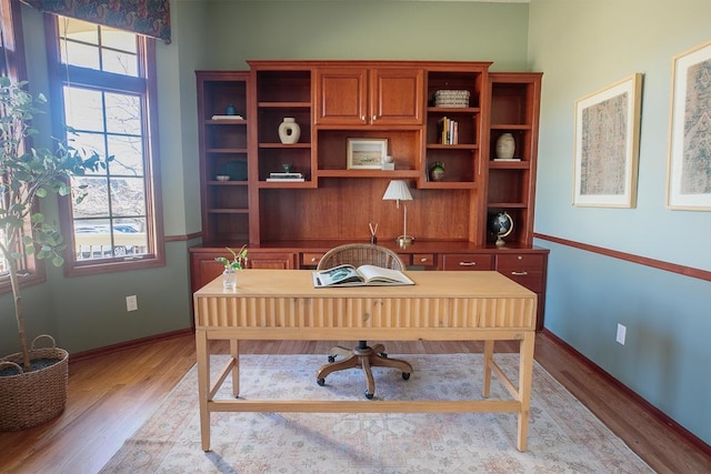 office featuring light wood-type flooring and baseboards