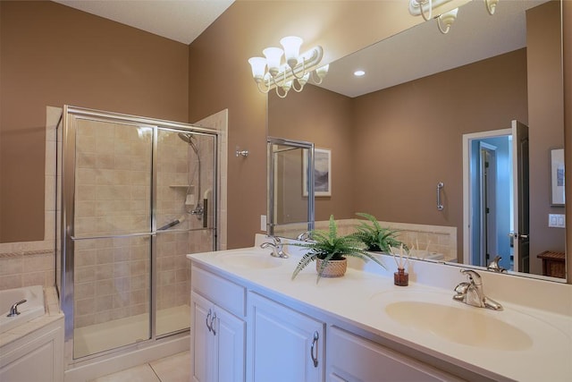 bathroom featuring a notable chandelier, a shower stall, a sink, and tile patterned floors