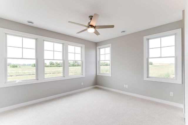 spare room with carpet flooring and ceiling fan