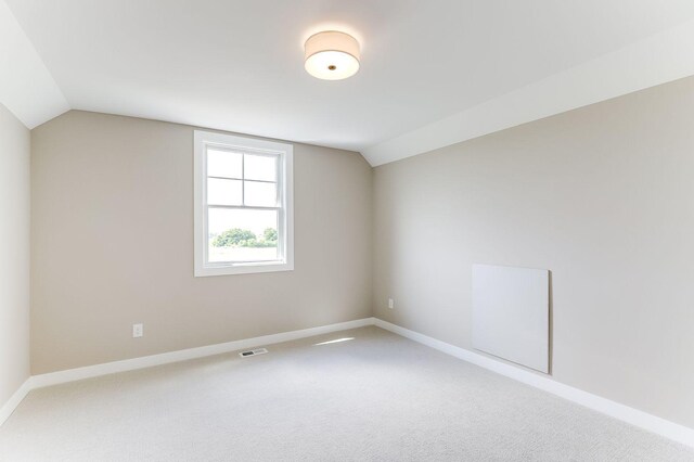 bonus room featuring carpet and vaulted ceiling