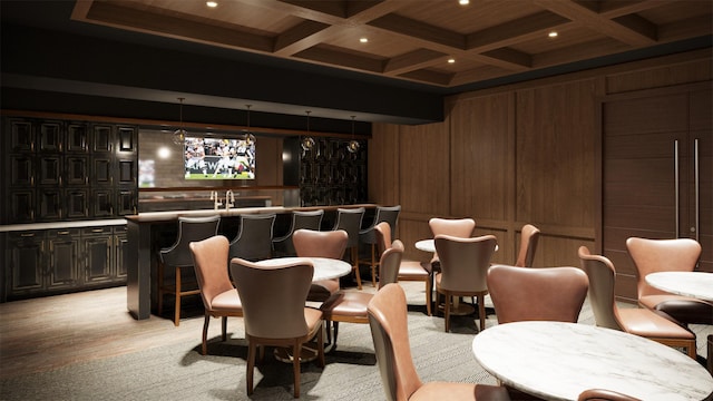 cinema with beamed ceiling, light hardwood / wood-style flooring, wooden walls, and coffered ceiling