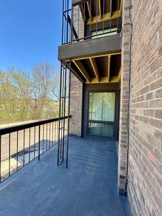 view of patio featuring a balcony
