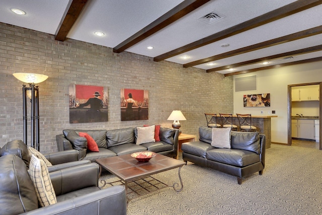 living area with light colored carpet, brick wall, baseboards, beamed ceiling, and visible vents