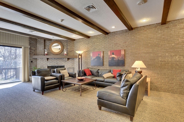 living room with visible vents, a brick fireplace, brick wall, beamed ceiling, and carpet
