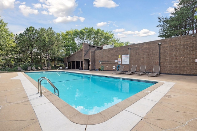 community pool with a patio area