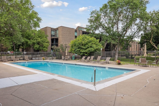 pool featuring a patio area and fence