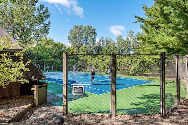 view of tennis court with fence