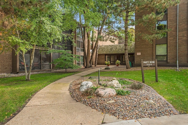 view of home's community with a yard