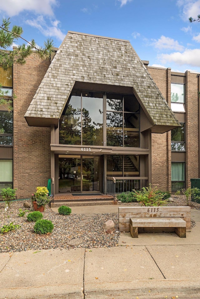 view of exterior entry featuring brick siding