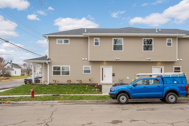 rear view of property featuring a yard