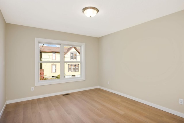 unfurnished room with light wood-type flooring