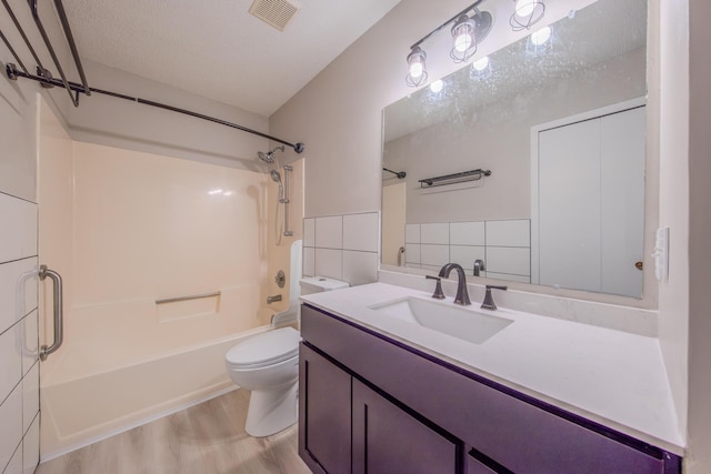 full bathroom with shower / bathing tub combination, vanity, toilet, tile walls, and wood-type flooring