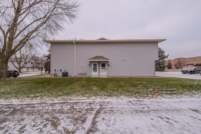 snow covered house with a lawn