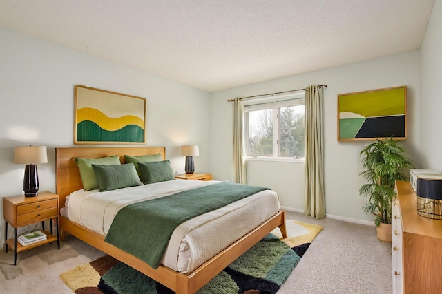 bedroom featuring light carpet and baseboards