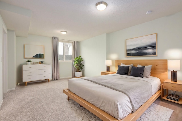 bedroom with light carpet and baseboards