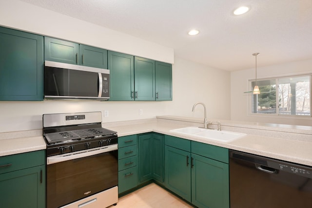 kitchen featuring appliances with stainless steel finishes, decorative light fixtures, light countertops, a sink, and recessed lighting