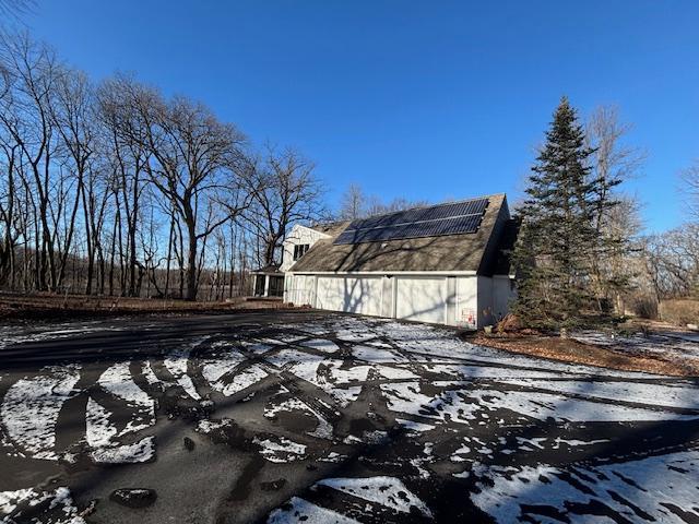 view of snow covered exterior with solar panels